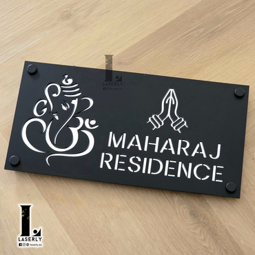 Laser-cut Ganesha Namaste house number plaque in matte black and reflective silver acrylic.