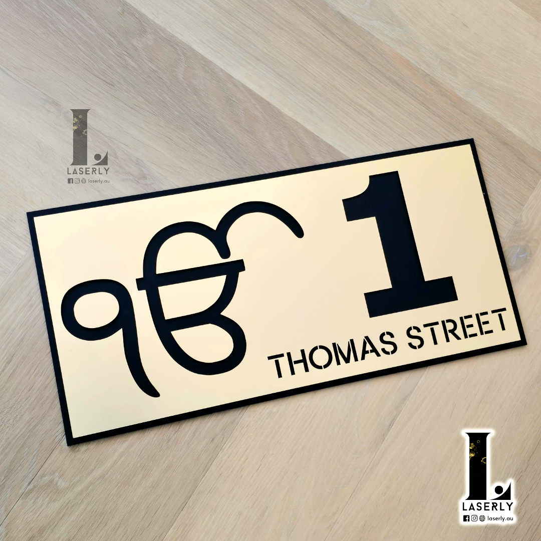 Modern spiritual Ek Onkar house number sign on contemporary home façade.