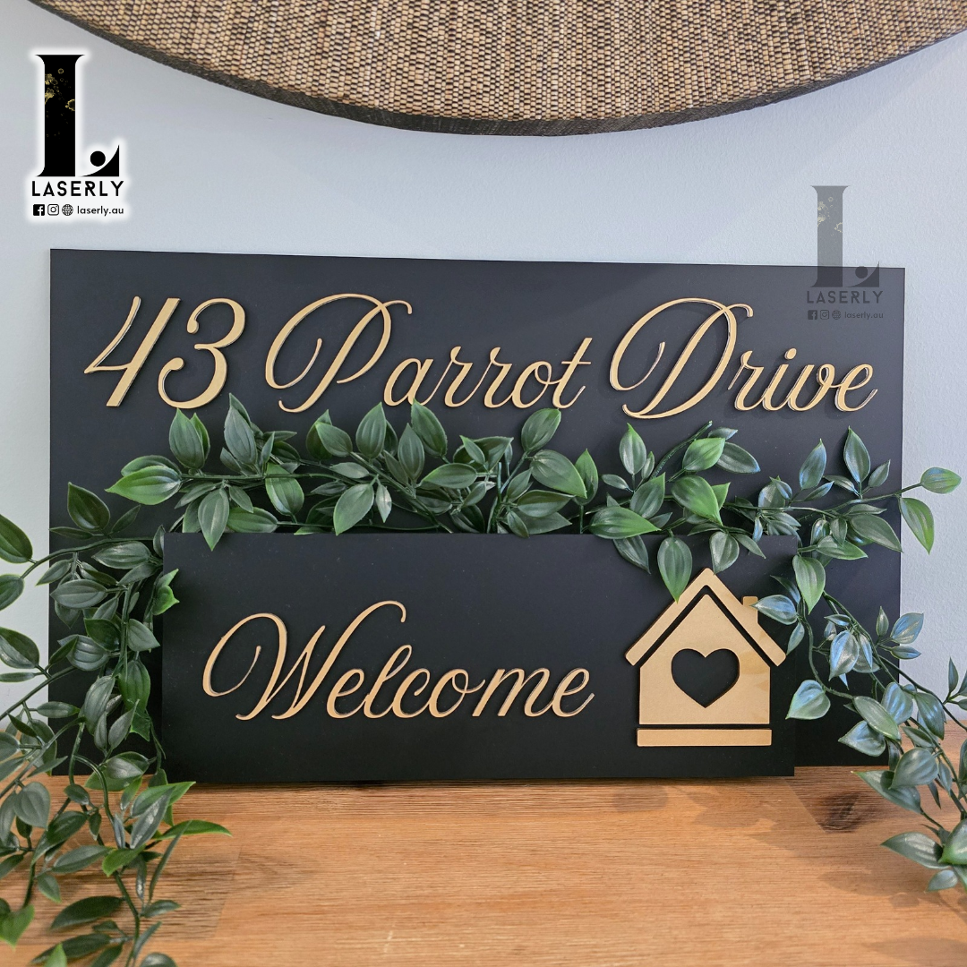 Minimalist house number planter displayed near entrance with fresh green foliage.