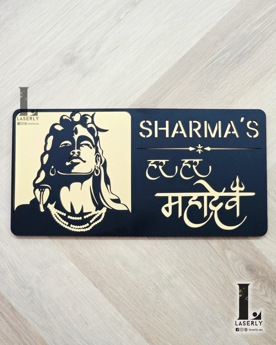 Modern Mahadev house number sign in gold and black acrylic, mounted beside front door.