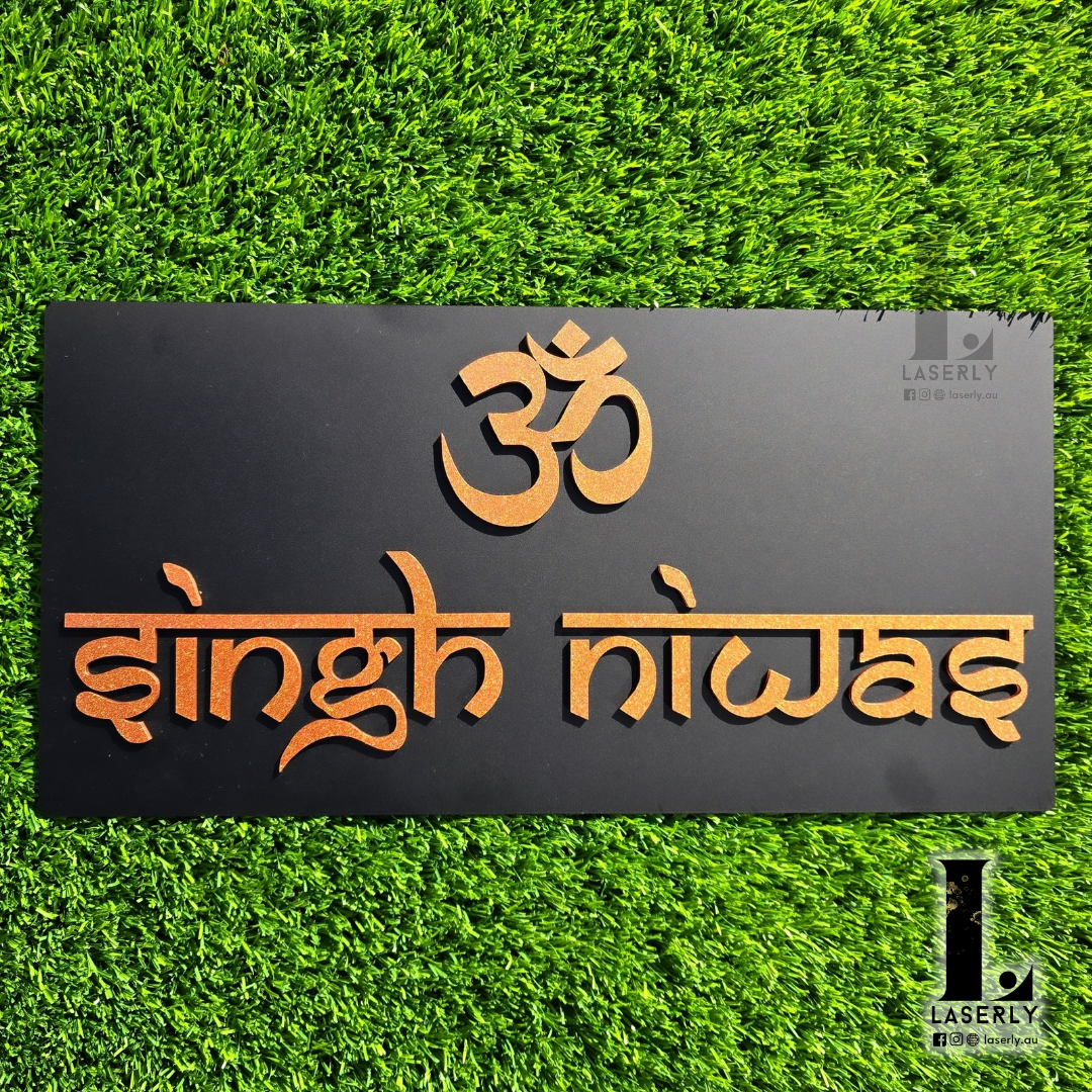Modern wall-mounted house number sign with Om symbol in black and bronze acrylic.