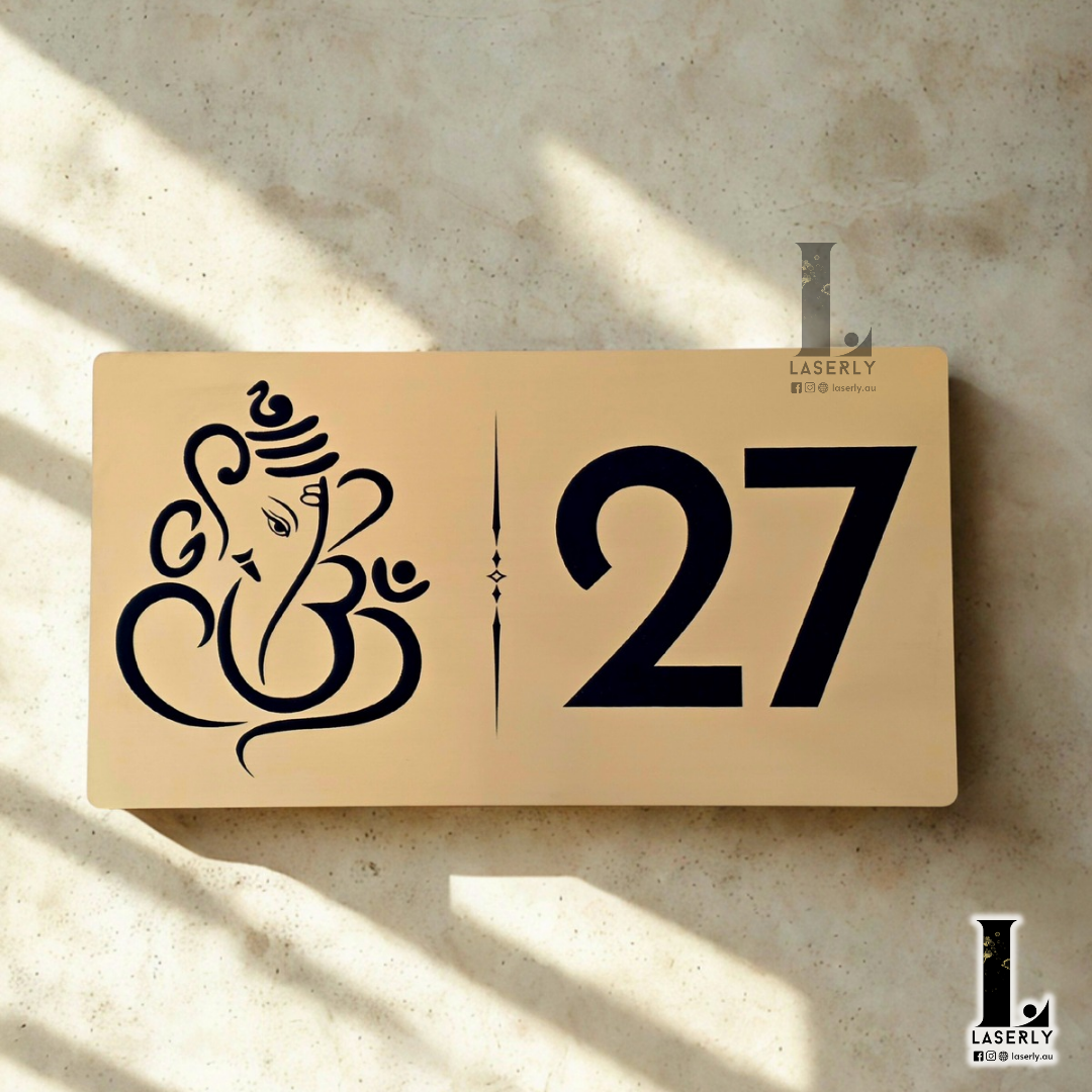 Elegant Ganesha house number plaque in brushed gold finish with engraved detailing.