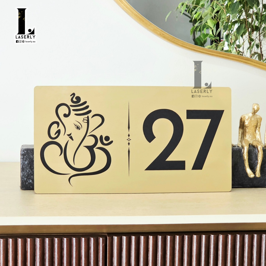 Modern brushed gold Ganesha house number sign with precision engraving for home entrance.
