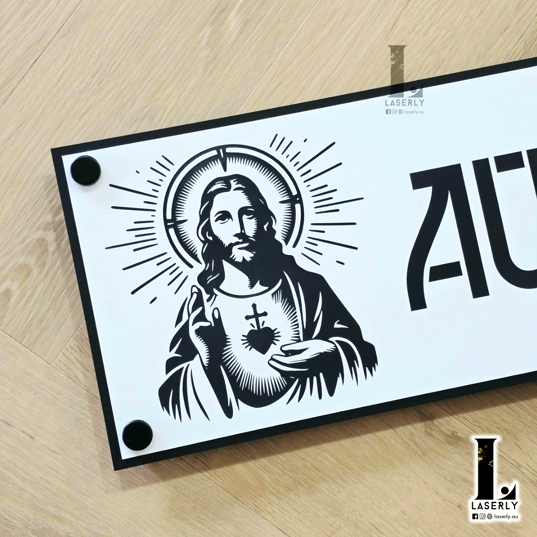 Contemporary Jesus house name plate fixed on rendered exterior wall.
