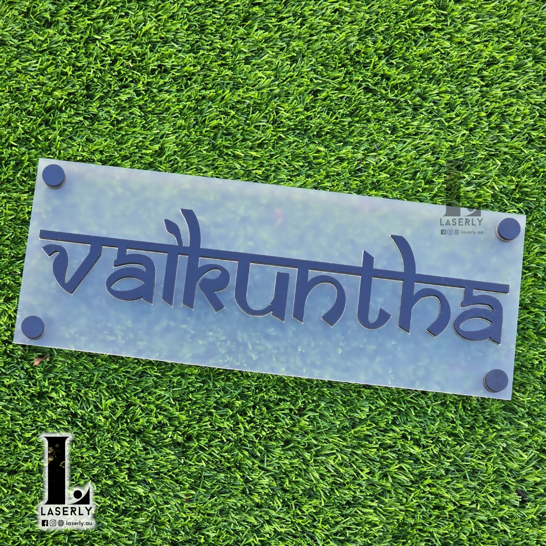 Contemporary acrylic house name sign with clear lettering for outdoor use.