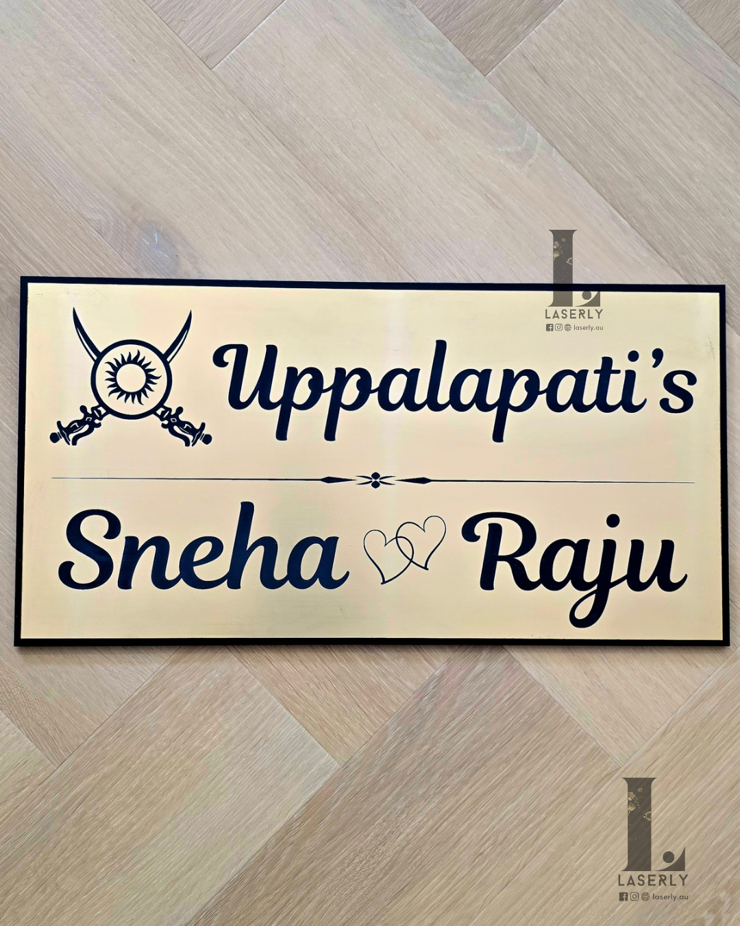 Modern Kshatriya house number sign mounted beside front door on exterior wall.