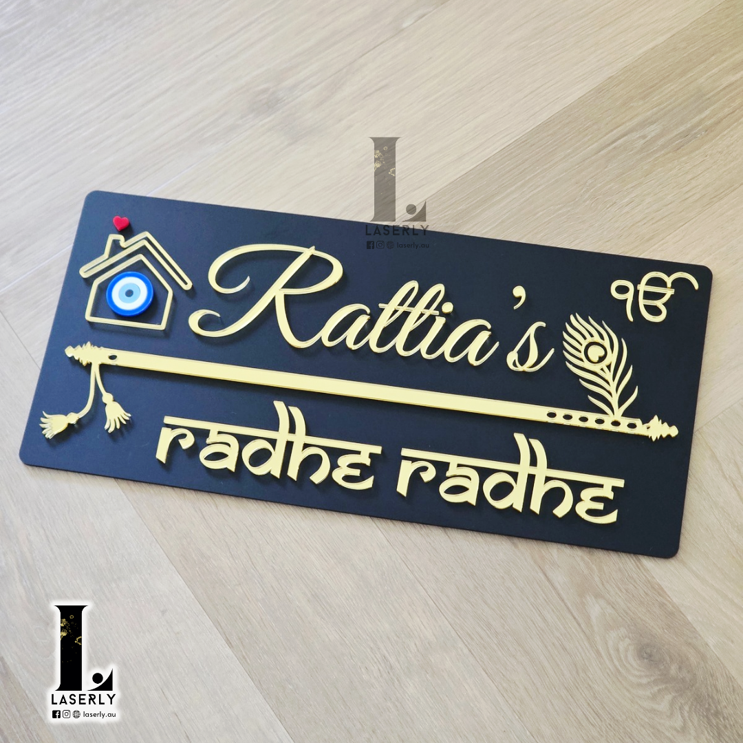 Modern black house number plaque with flute motif and blue evil eye detail beside front door.