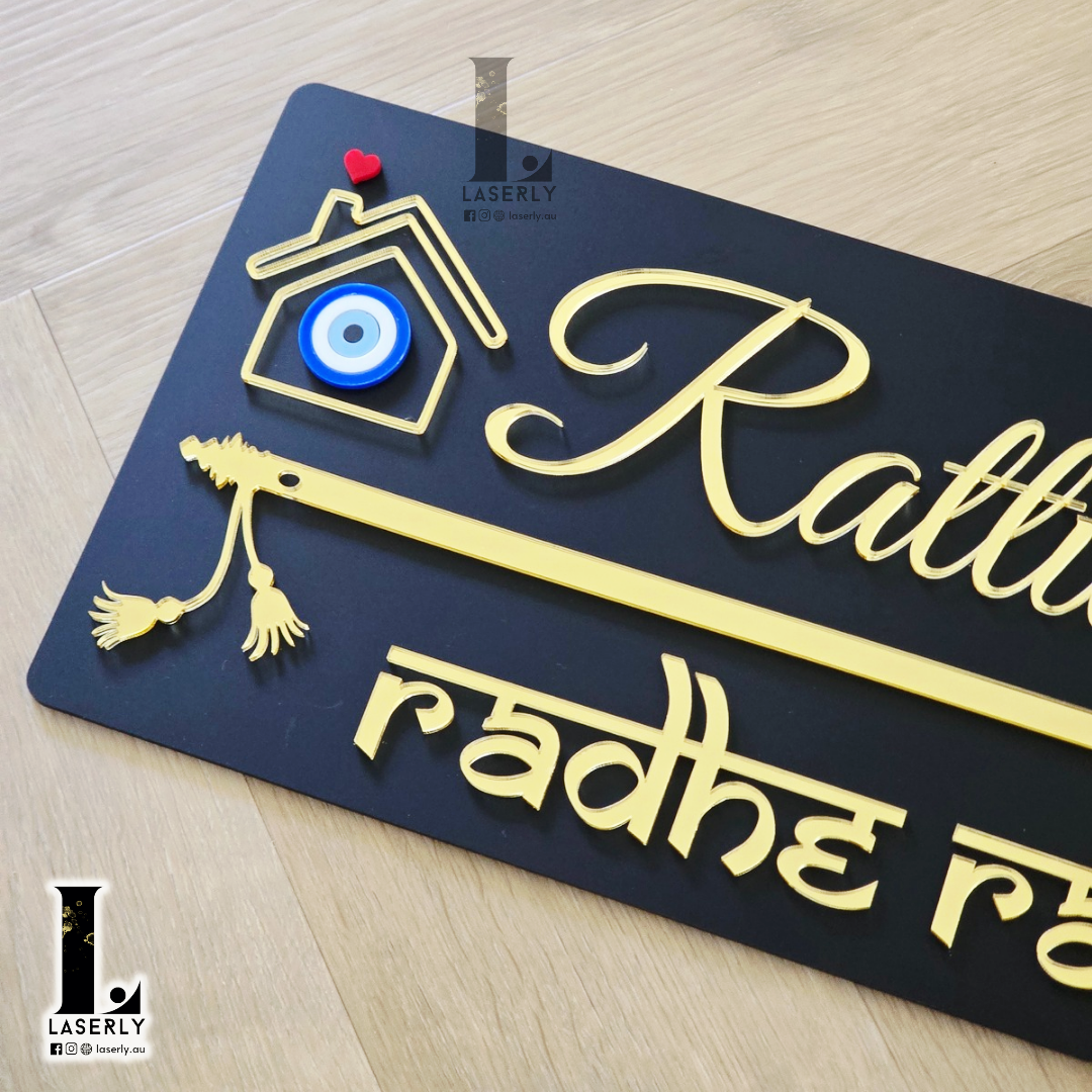 Stylish black wall-mounted house number plaque featuring flute-inspired design and evil eye embellishment.