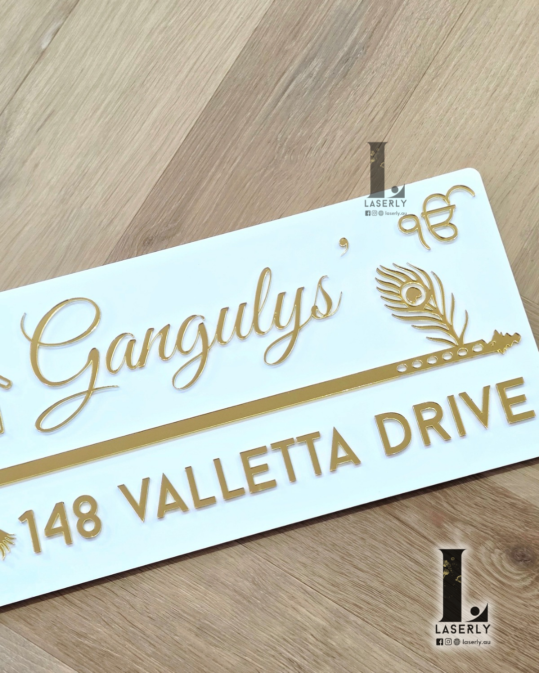 Laser-cut white acrylic house number sign with elegant flute motif and protective evil eye detail.
