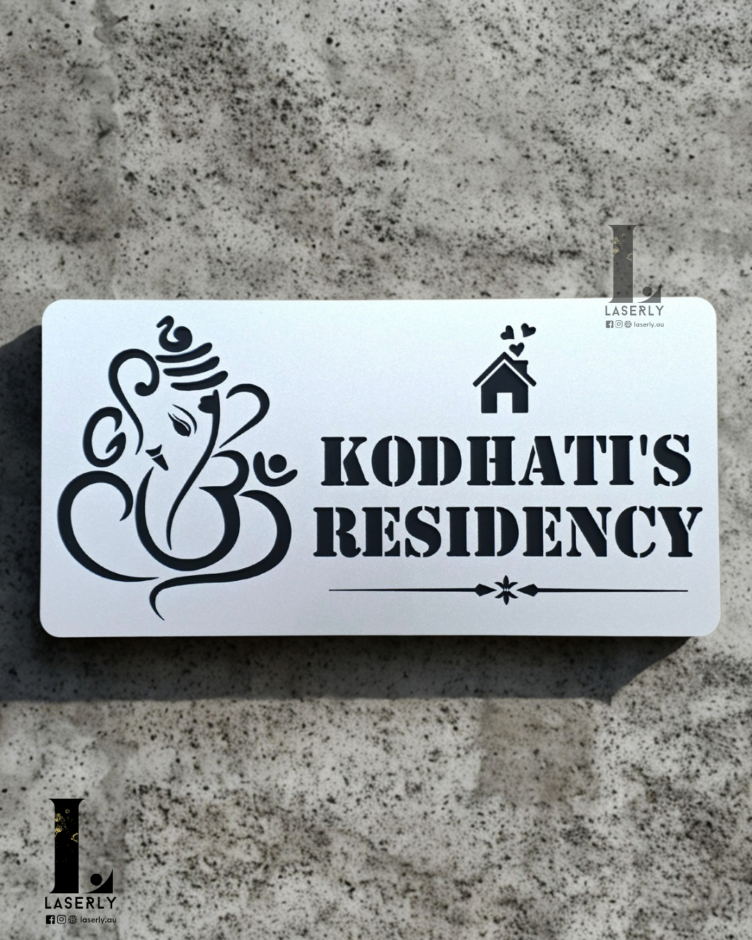 Modern Ganesha house number sign in steel-look acrylic mounted beside a contemporary front door.