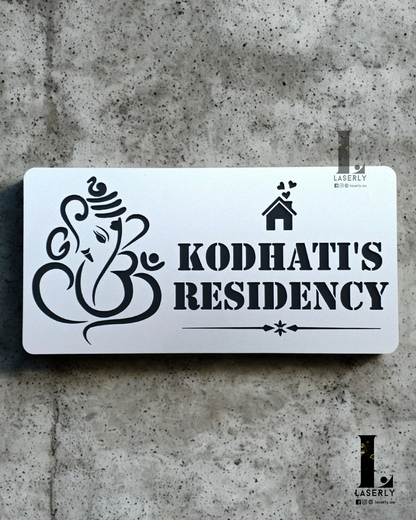 Contemporary Ganesha address sign crafted in steel-finish acrylic, installed next to doorway.