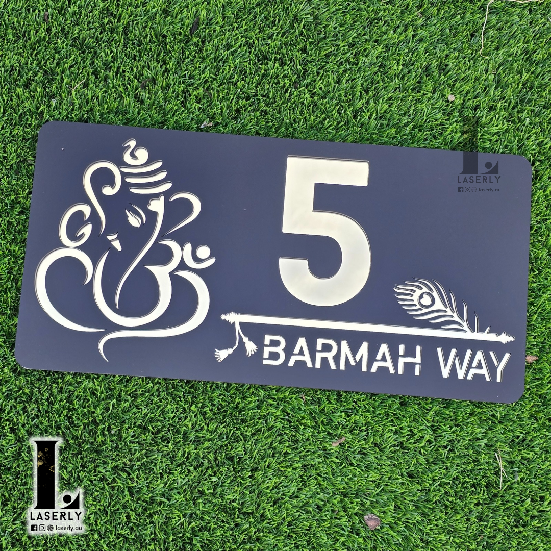 Laser-cut spiritual house number sign with Ganesha and Krishna motif beside front door.
