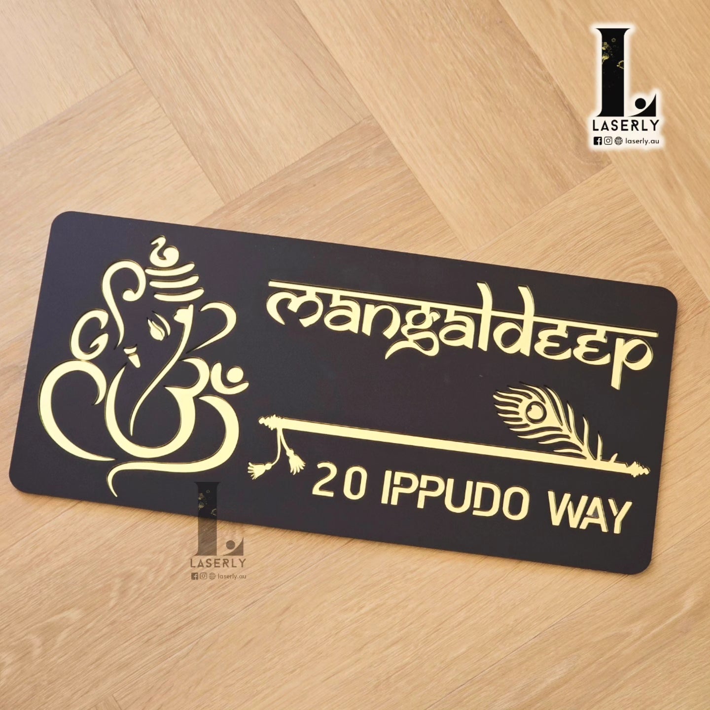 Front entrance wall displaying intricate Ganesha and Krishna flute house number plaque.