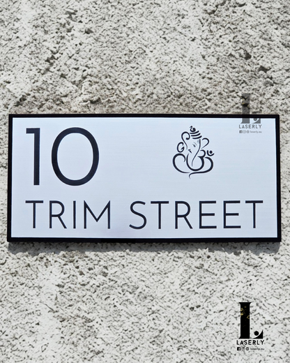 Sleek Ganesha-themed house number plate in minimalistic style beside front door.