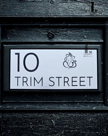 Modern minimalistic house number sign featuring Lord Ganesha design, mounted on exterior wall.
