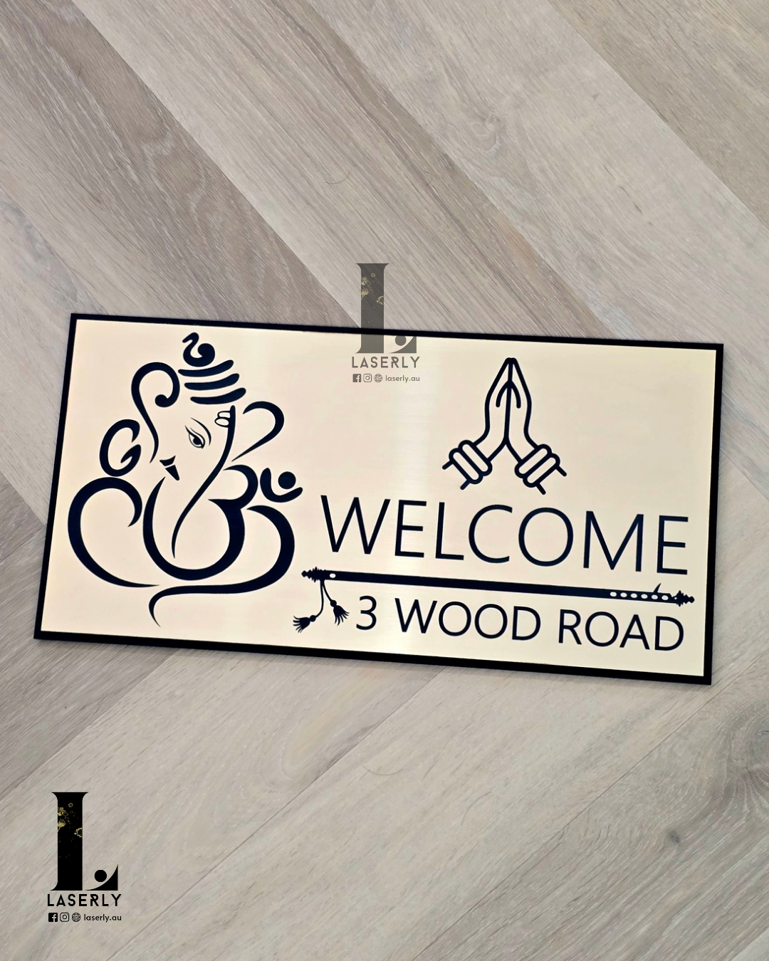 Modern acrylic Ganesha Namaste house number sign with intricate flute design beside front door.