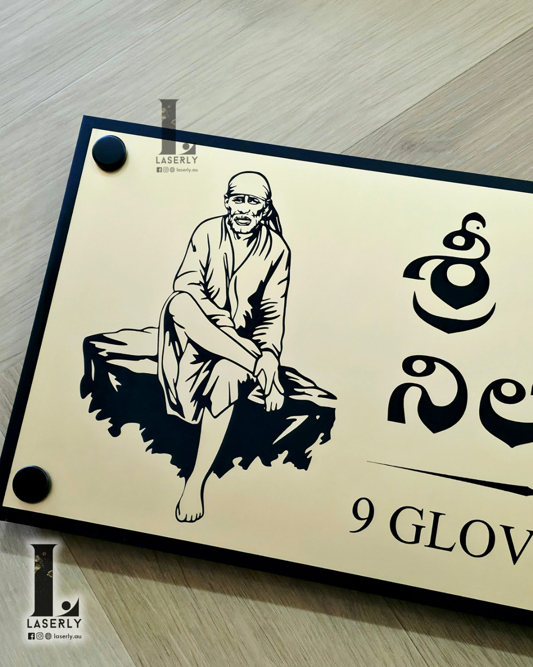 Decorative Sai Baba house number sign mounted on exterior wall near entrance.
