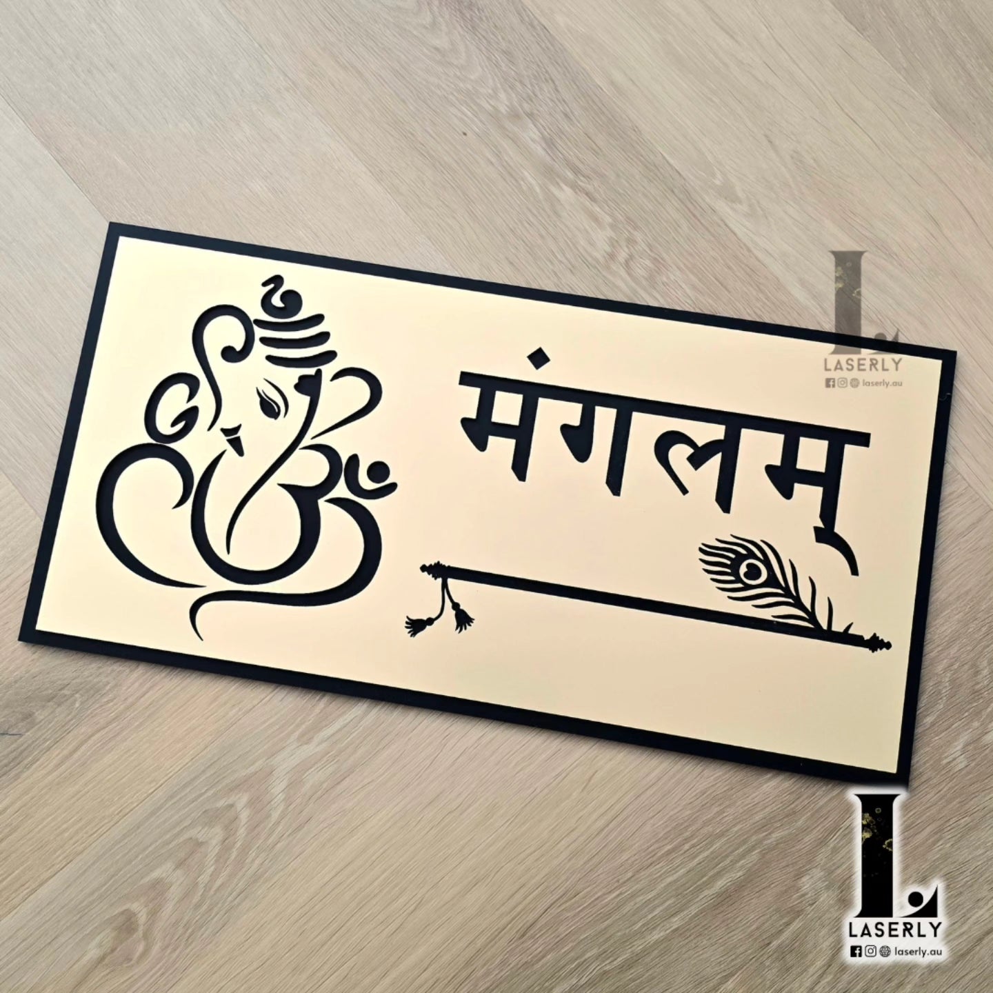 Decorative gold house number sign featuring Lord Ganesha and Krishna’s flute design mounted on exterior wall.