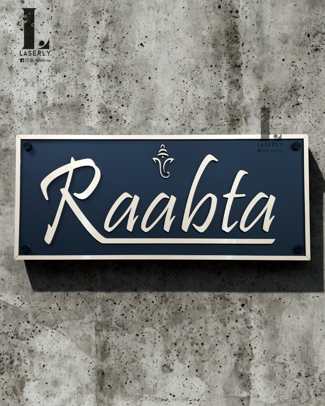 Gold and matte black acrylic Ganesha house number sign mounted beside a modern front door exterior wall.