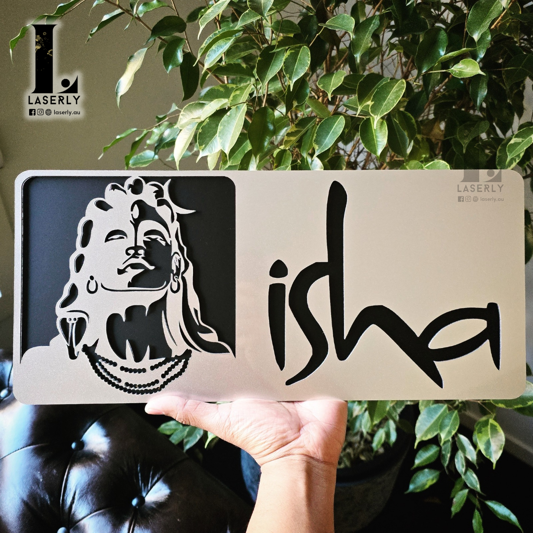 Stylish Isha house number sign fixed near doorway on residential facade.