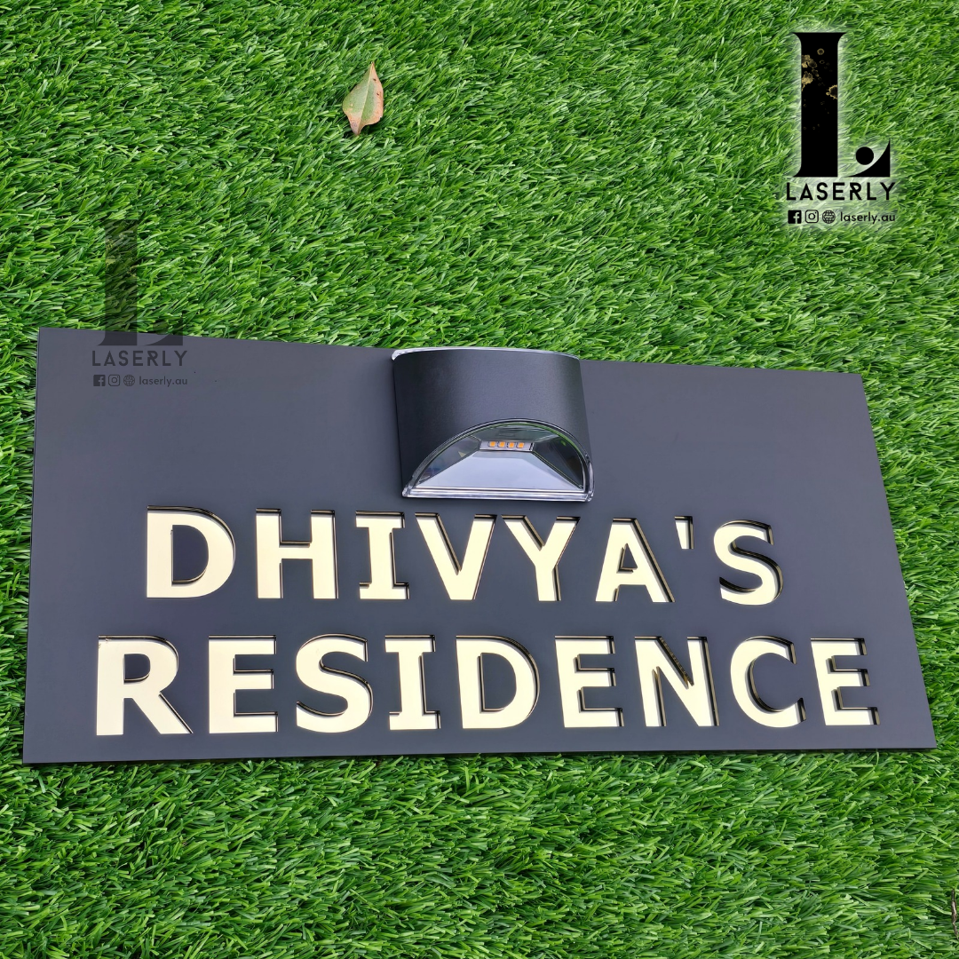 Horizontal house number sign with integrated solar light mounted beside a modern front door.