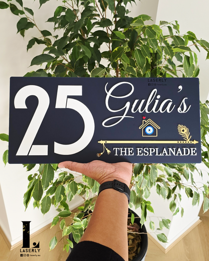 Rectangular navy blue house number plaque with protective evil eye motif and intricate flute pattern.