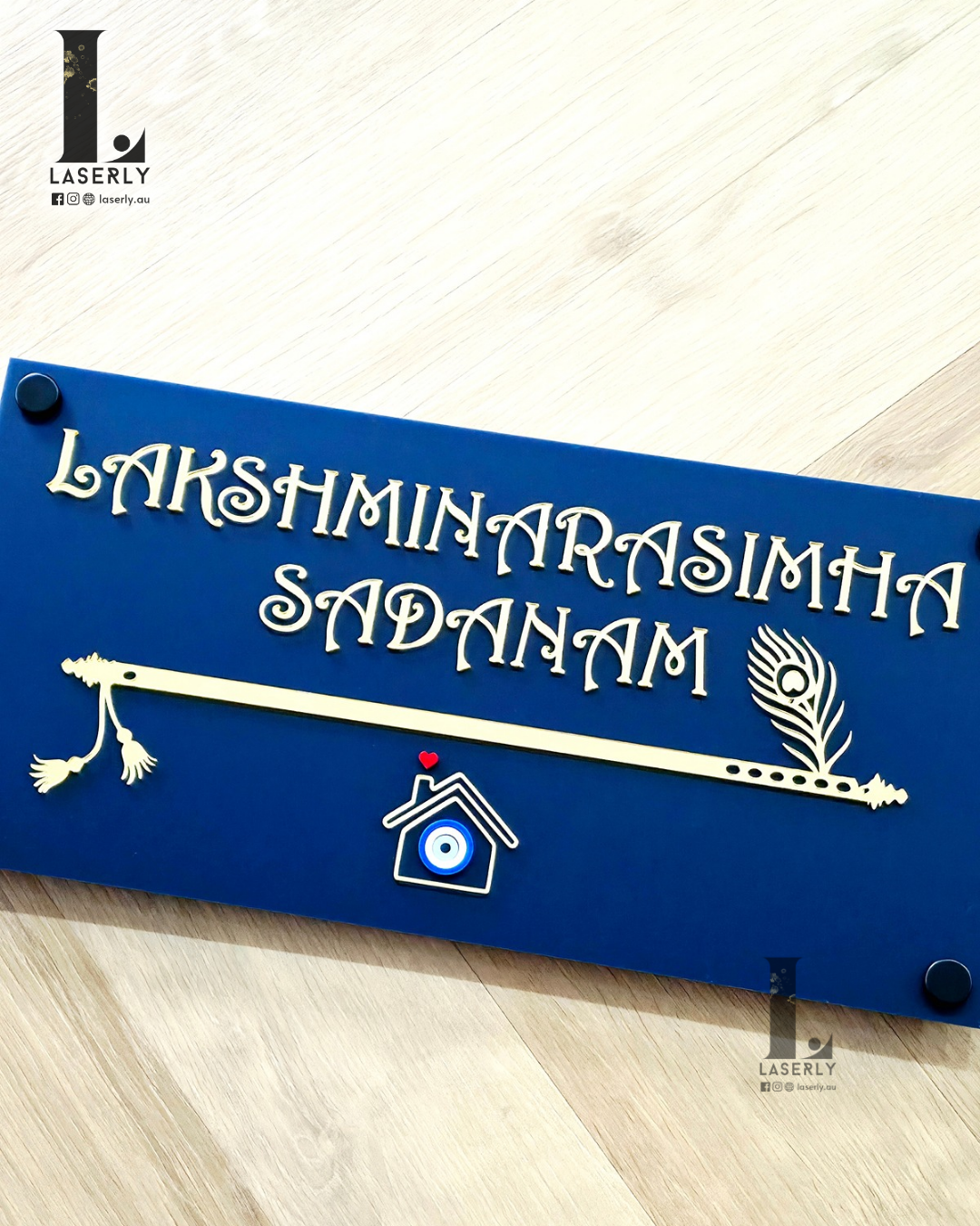 Elegant navy blue plaque displaying house numbers with flute pattern and protective evil eye.