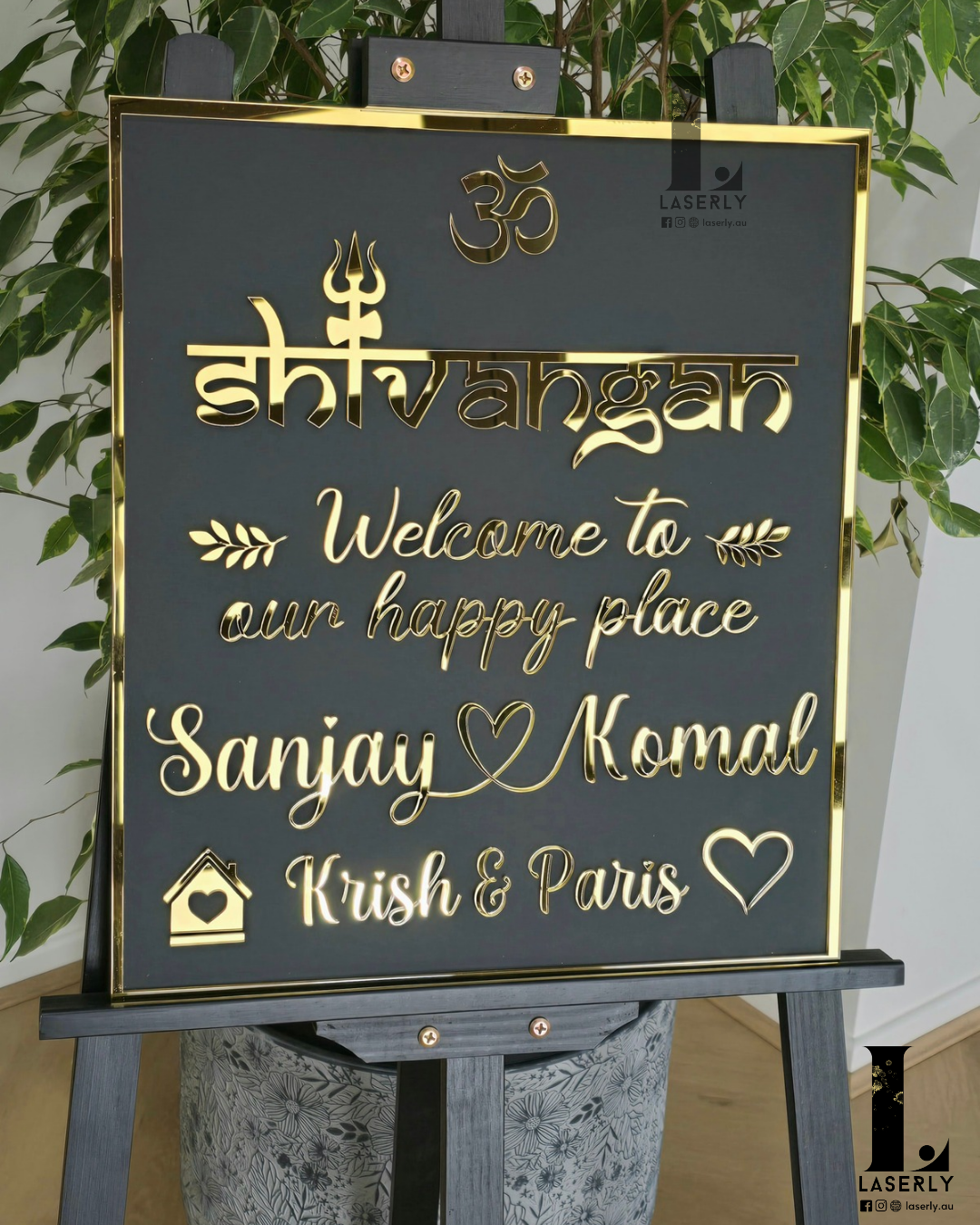 Laser-cut Om Shiva house number sign in black and gold finish on home façade.