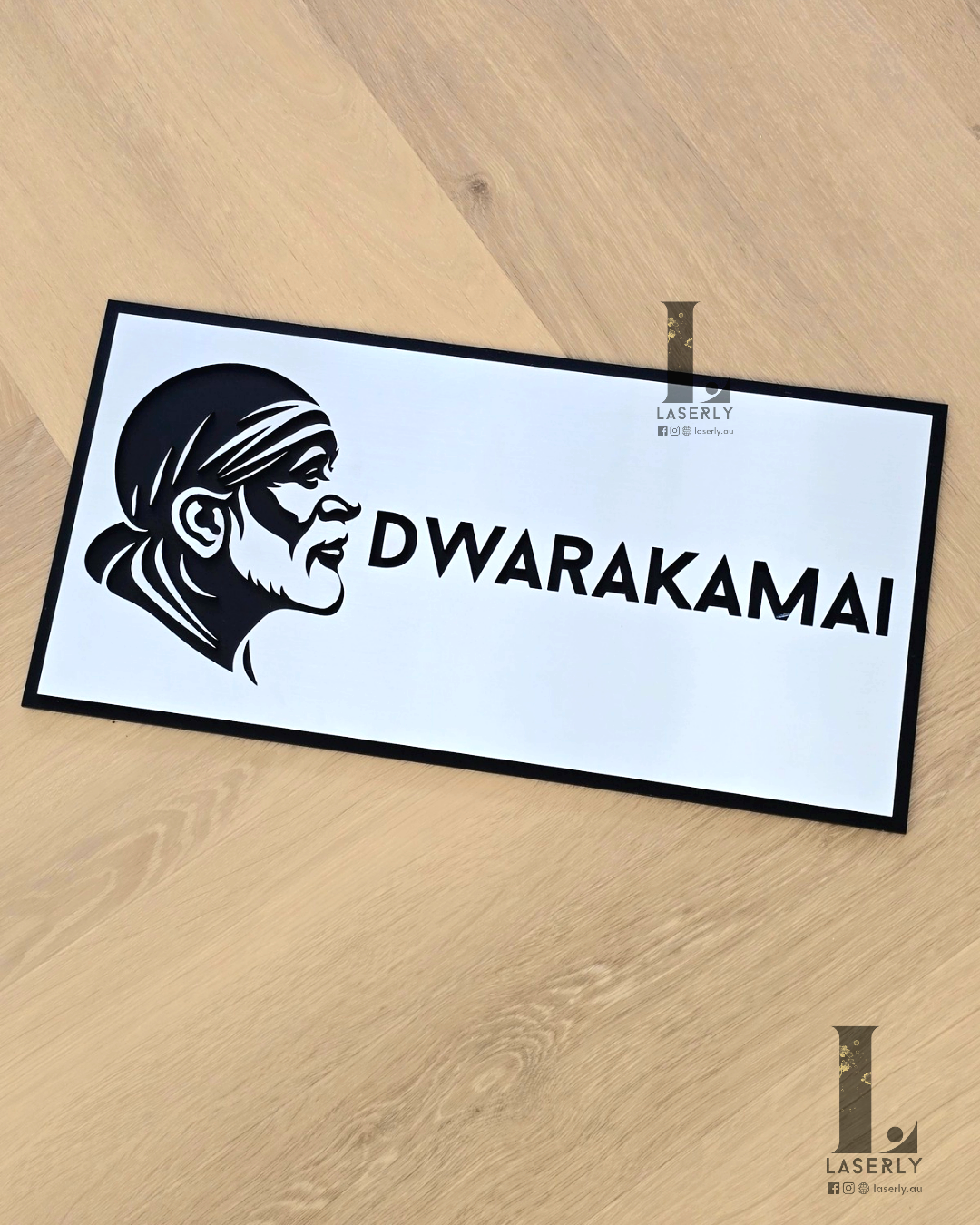 Modern Saibaba house number sign in silver and black finish installed on a home wall.