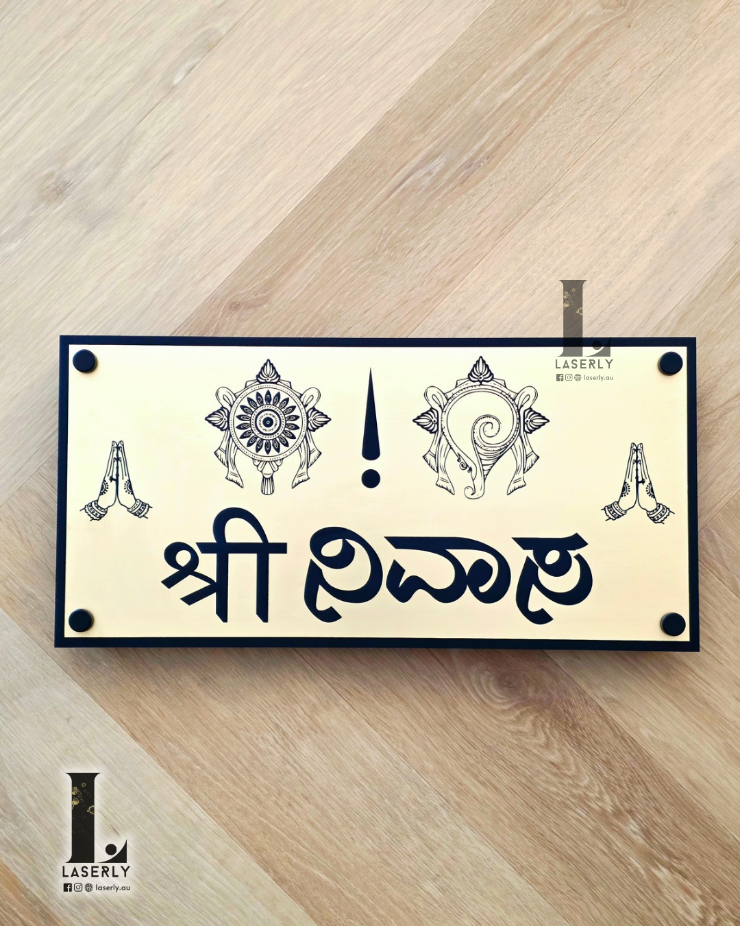 Modern Srinivasa house number sign mounted beside the front door on exterior wall.