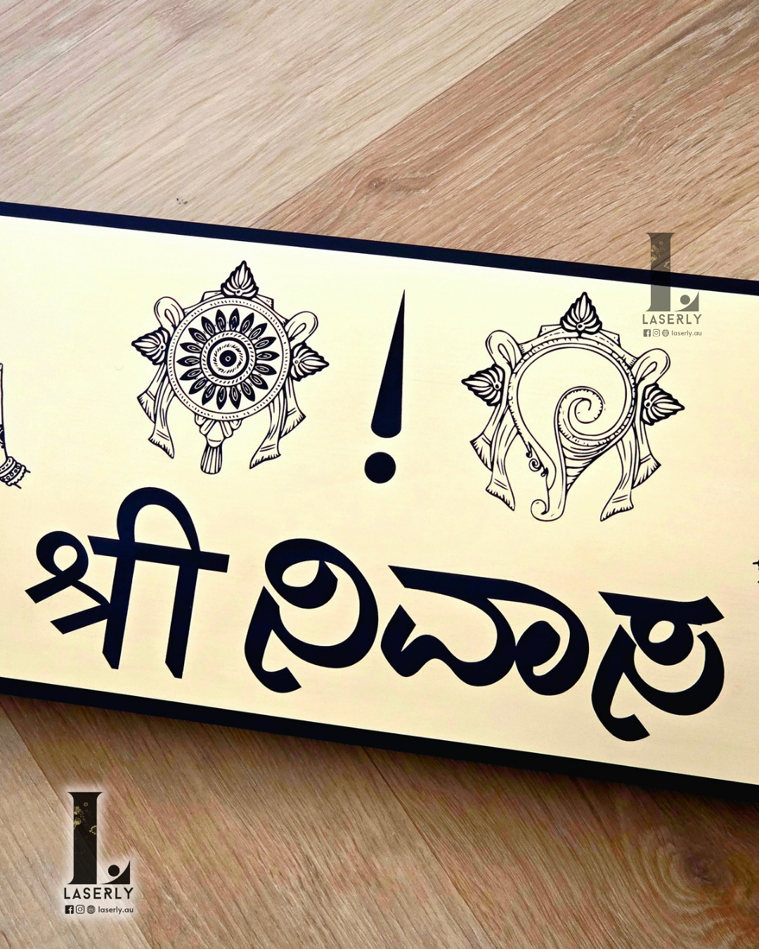 Close-up of Srinivasa house number sign with sleek gold and black design.