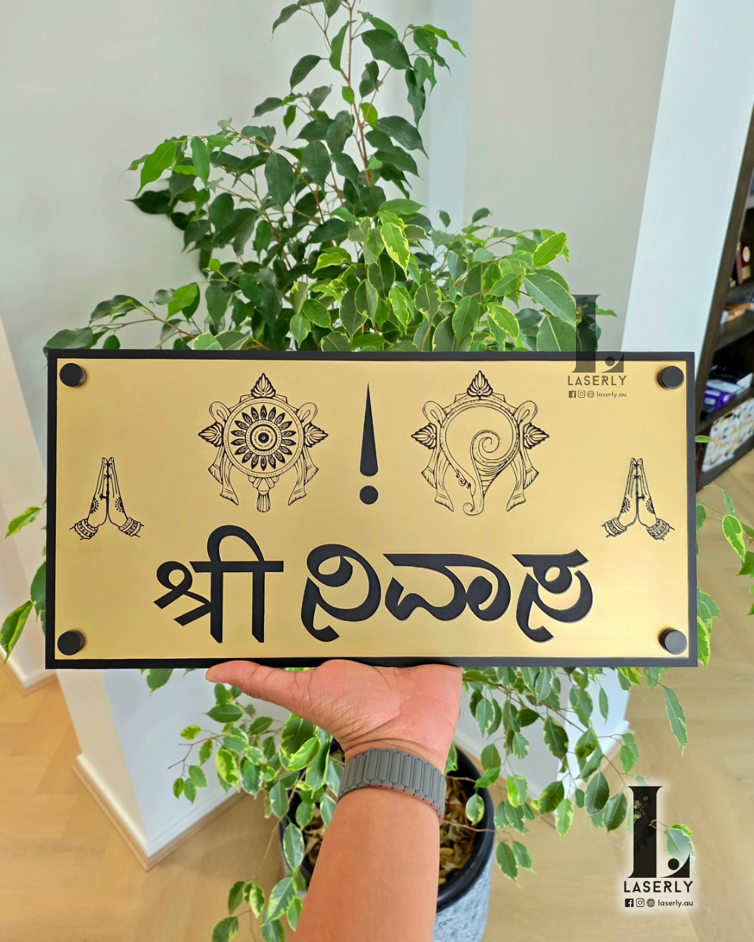 Srinivasa home number sign fixed on wall, adding a stylish touch to entrance.