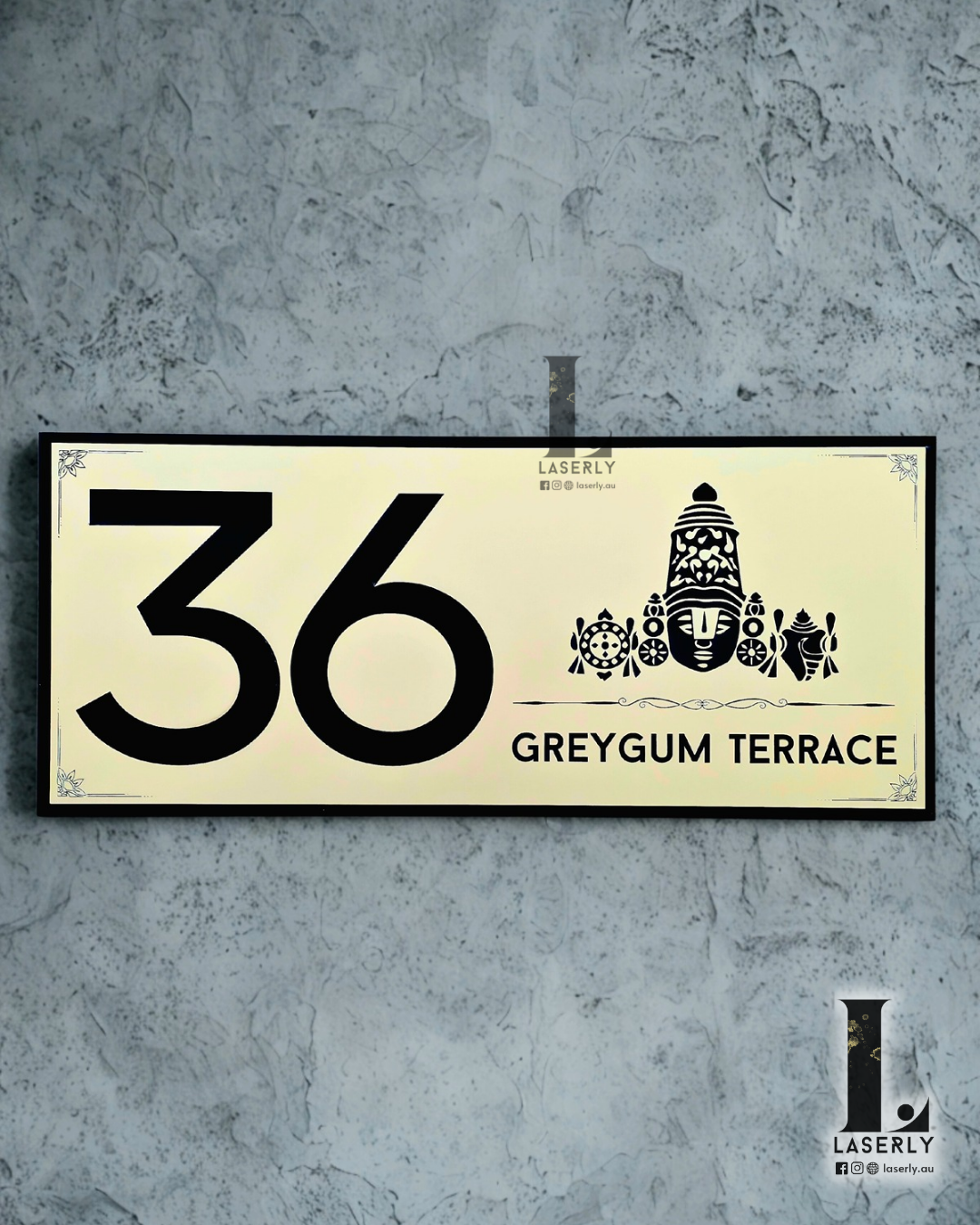 Modern Thirumala house number sign mounted on a sleek exterior wall.