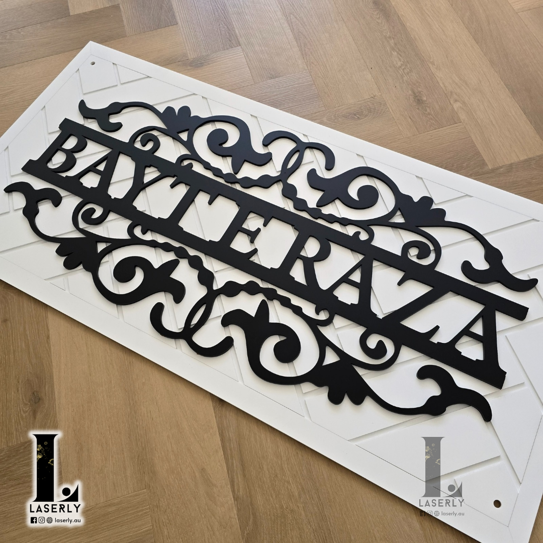 White patterned house name sign adding a touch of elegance to the front exterior.